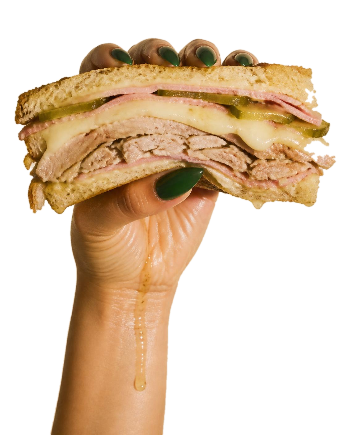 A hand holding a pressed Cuban sandwich