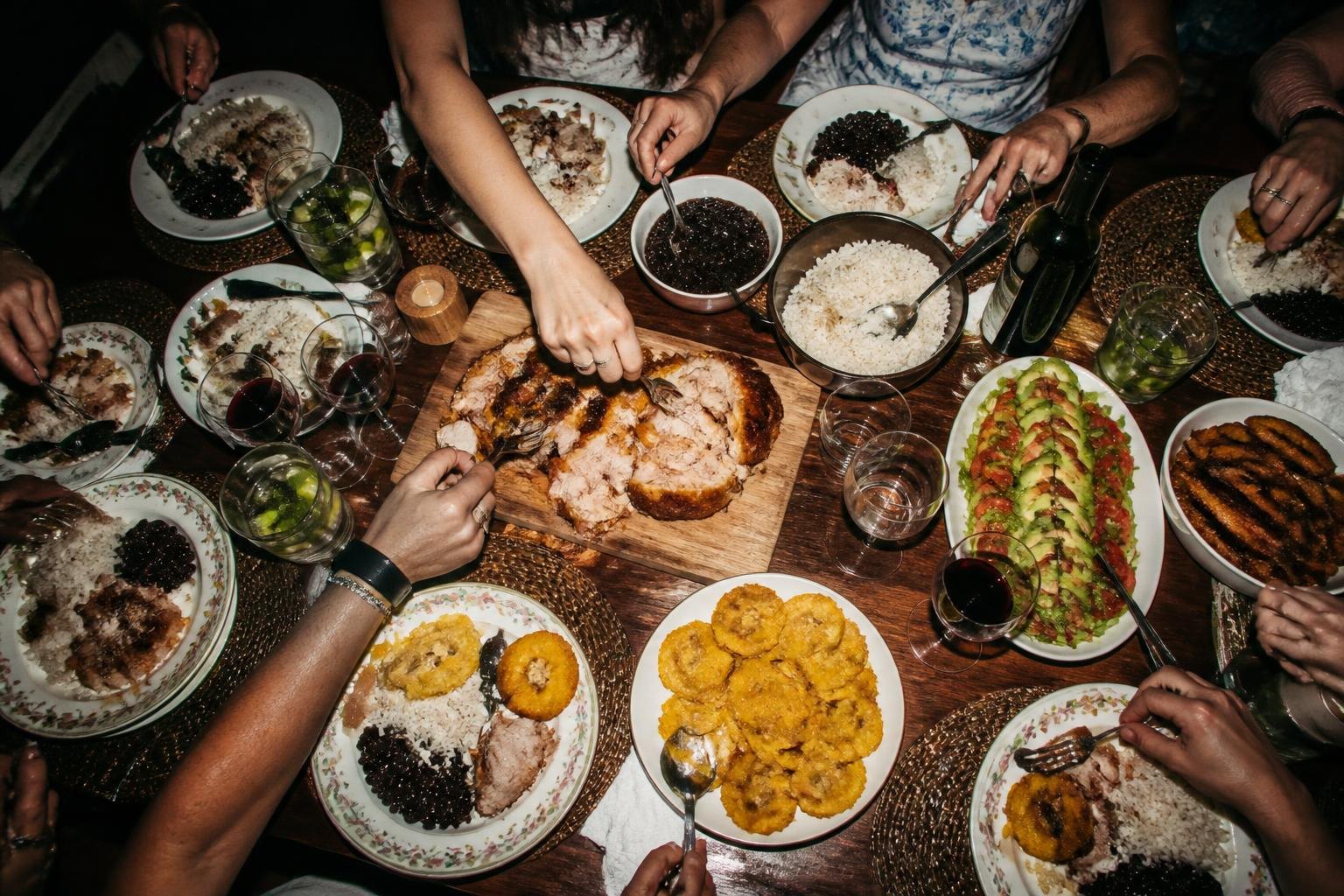 Family-style table, hands reaching in